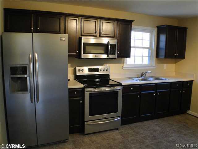 235 Wakema Road West Point, VA 23181 - Photo 3 of 9 a kitchen with stainless steel appliances granite countertop a refrigerator and a stove top oven
