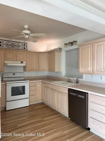 a kitchen with a stove cabinets and wooden floor