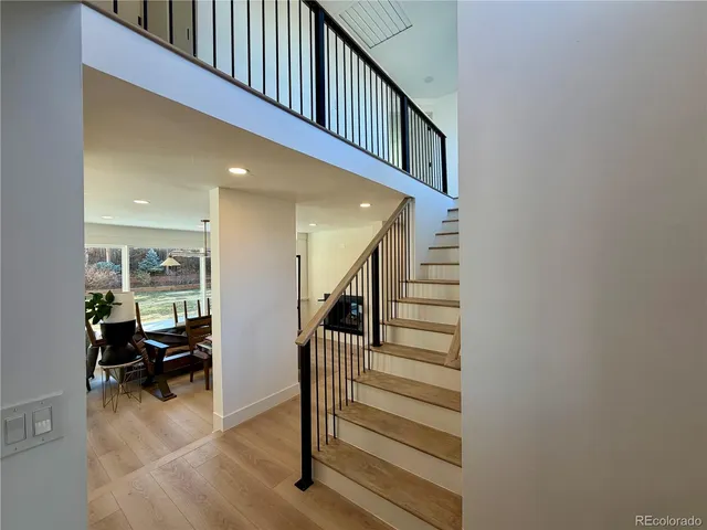 an empty room with windows and fireplace