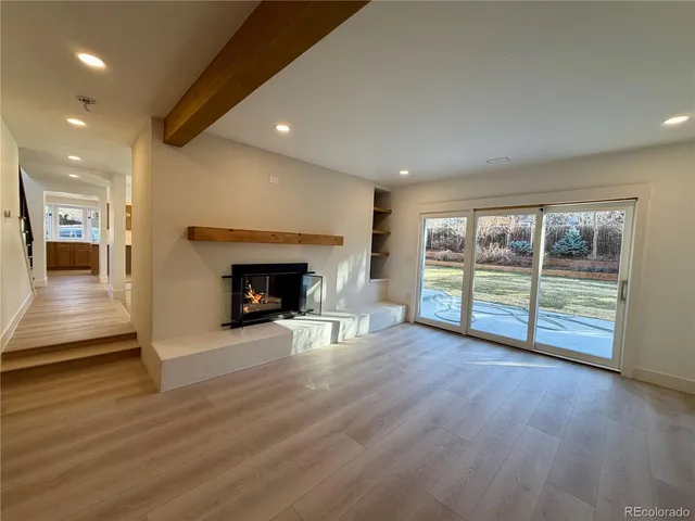 an empty room with wooden floor and white walls