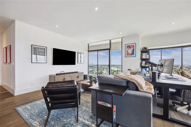 a view of a livingroom with furniture and a flat screen tv