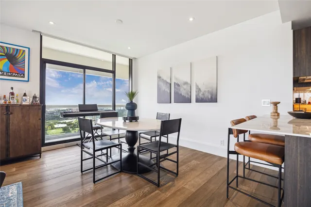 a view of a dining room with furniture window and wooden floor