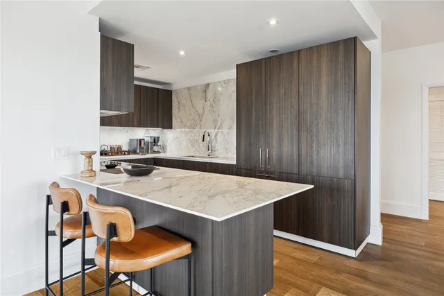a kitchen with a table chairs and a refrigerator
