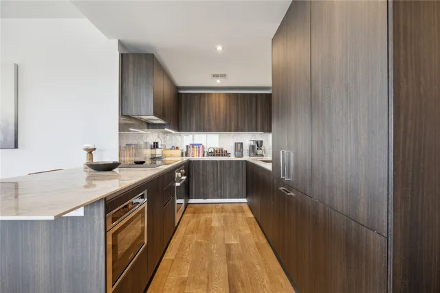 a kitchen with stainless steel appliances granite countertop a sink counter space and cabinets