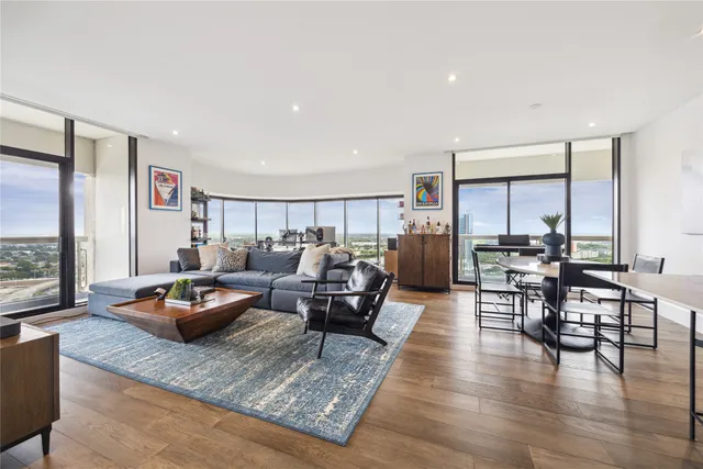 a living room with furniture and a wooden floor