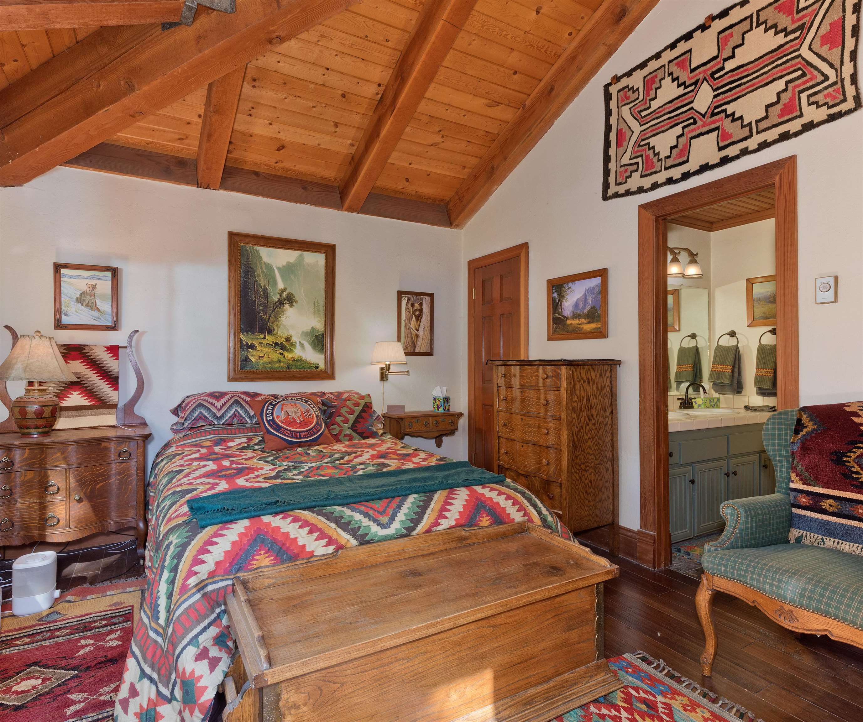 91 St Moritz Road Mammoth Lakes, CA 93546 - Photo 22 of 34 a bedroom with a bed and dresser with wooden floor