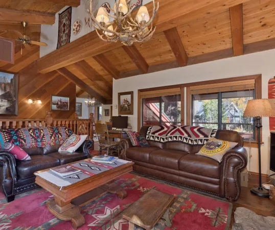 a living room with furniture a rug and a chandelier