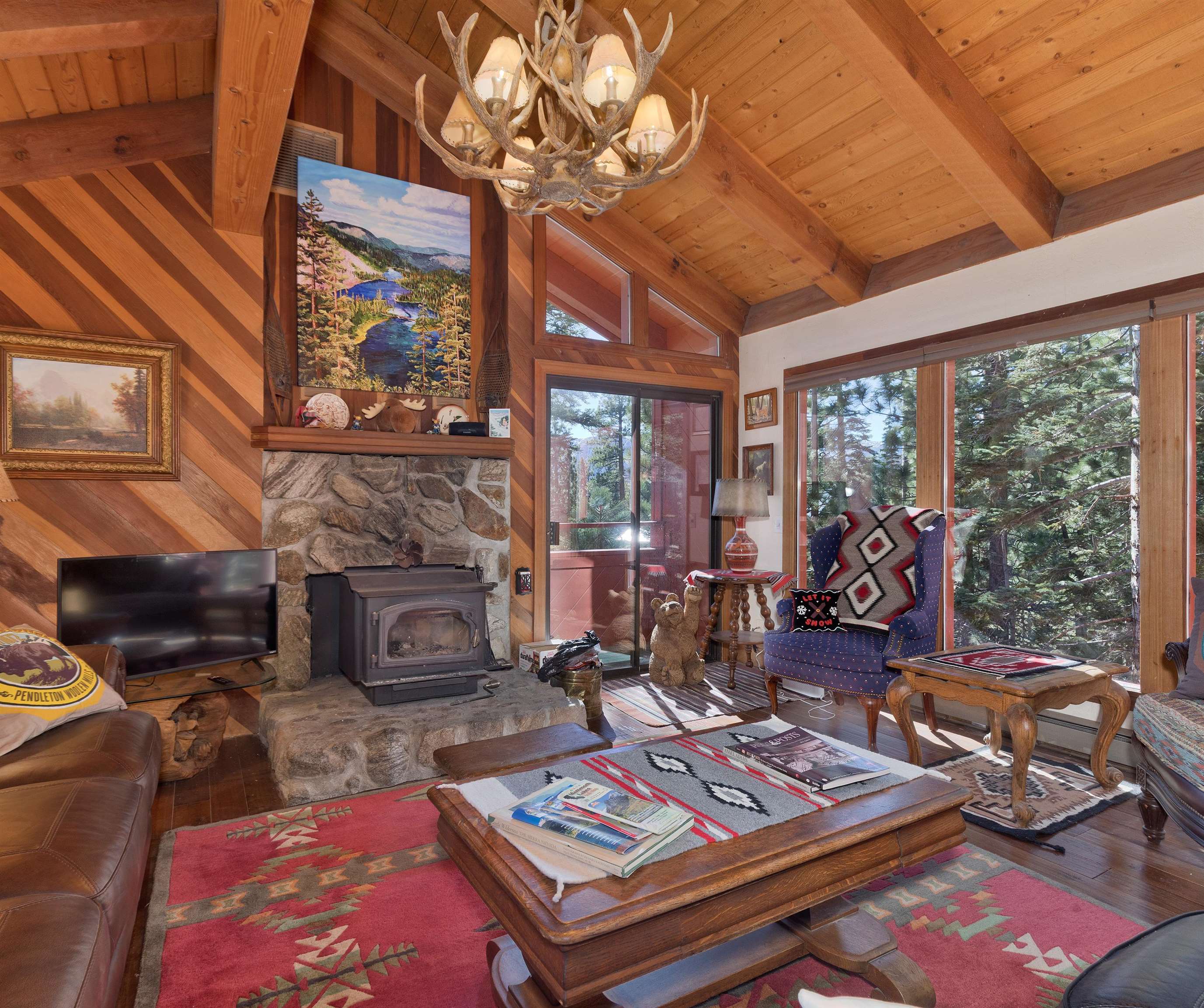 91 St Moritz Road Mammoth Lakes, CA 93546 - Photo 4 of 34 a living room with furniture a fireplace and large windows