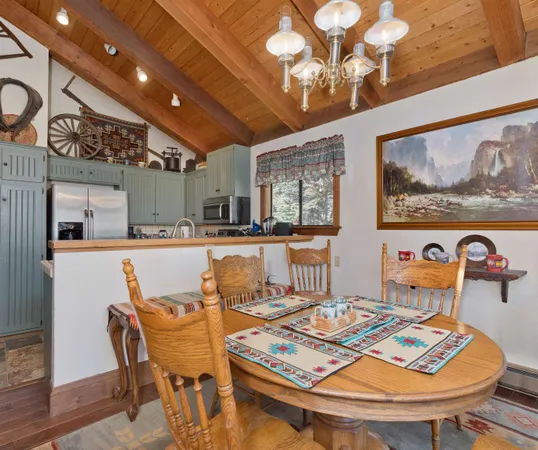 a dining room with furniture and wooden floor