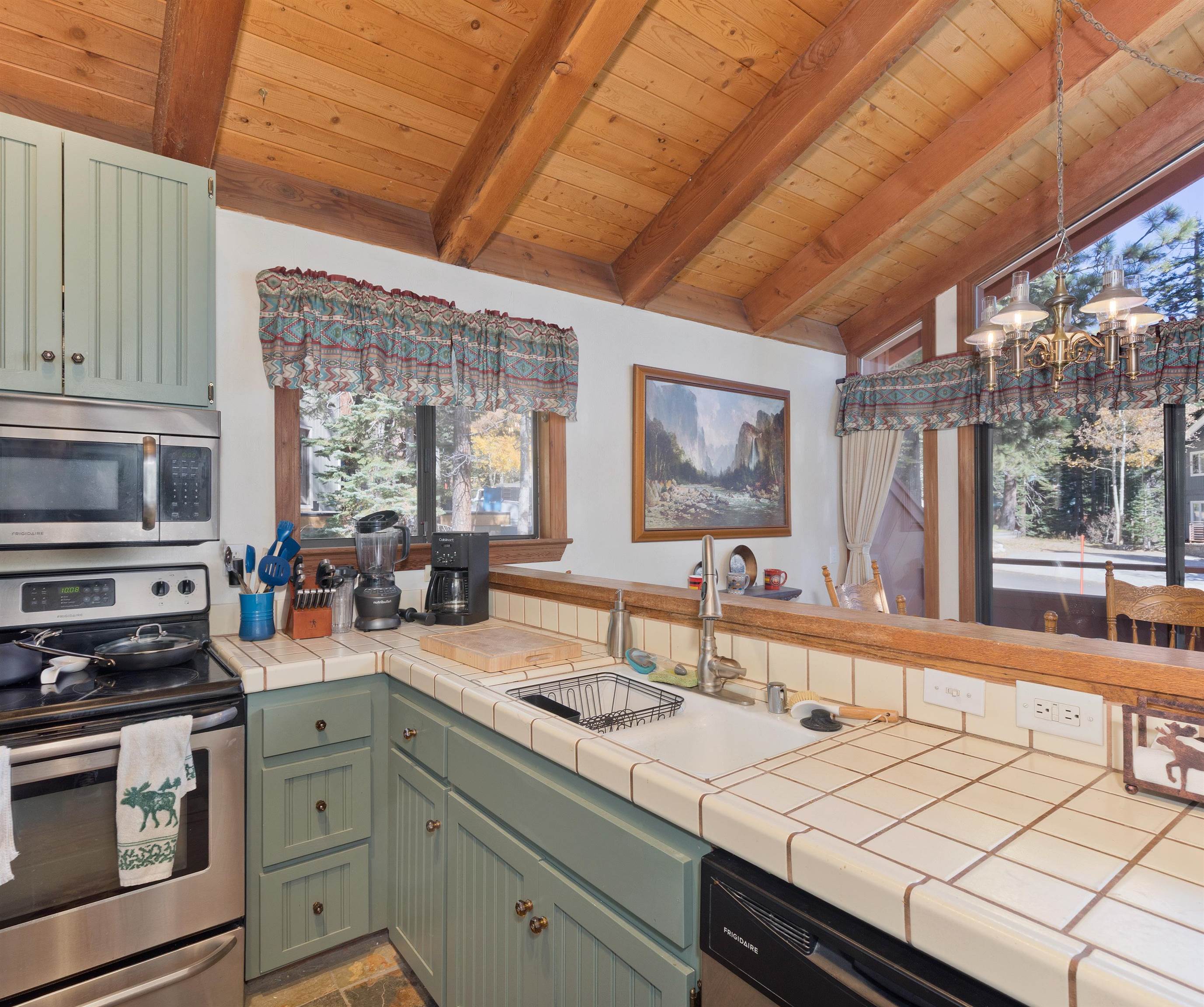 91 St Moritz Road Mammoth Lakes, CA 93546 - Photo 9 of 34 a kitchen with a sink stove and cabinets