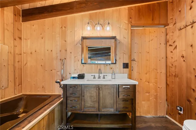 a bathroom with a sink a mirror and a bathtub
