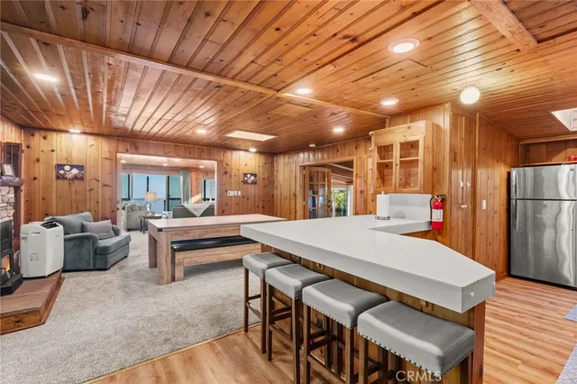 a dining room with a wooden table and chairs