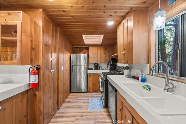 a kitchen with a sink stove and refrigerator