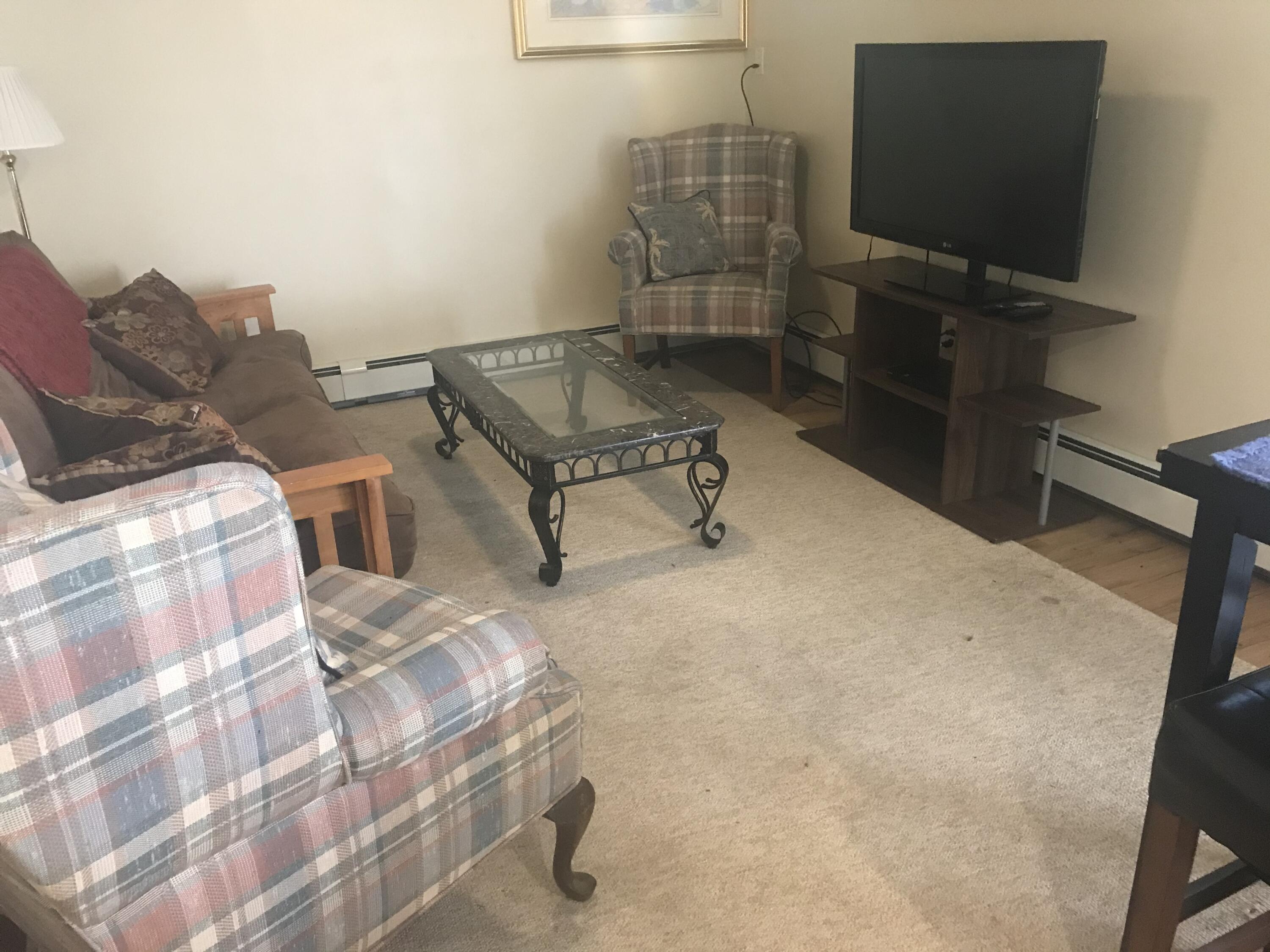 40 Daisy Hill Road Hyannis, MA 02601 - Photo 19 of 22 a living room with furniture and a flat screen tv
