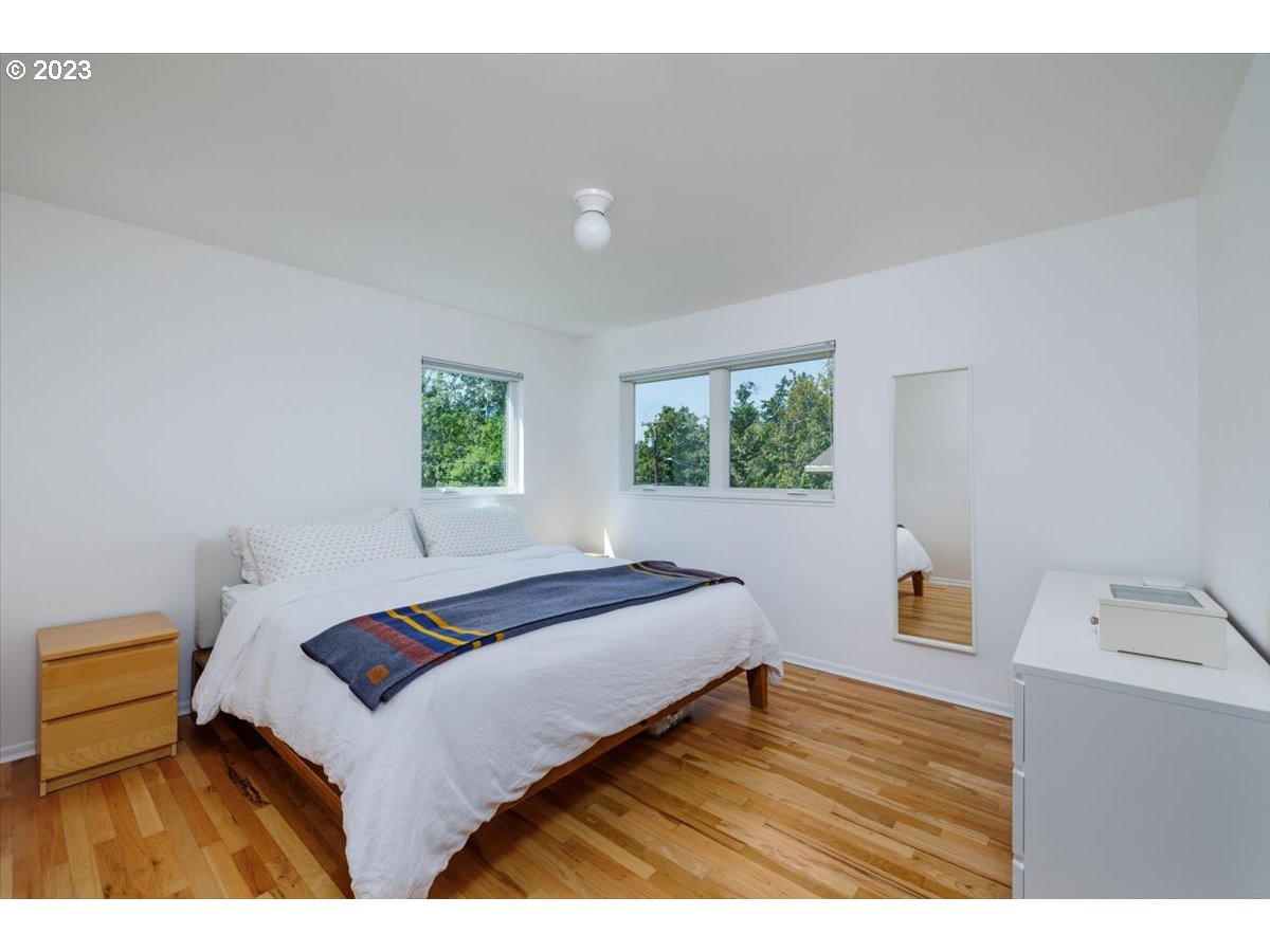 7519 Southwest 53rd Avenue Portland, OR 97219 - Photo 13 of 30 a bedroom with a bed and wooden floor