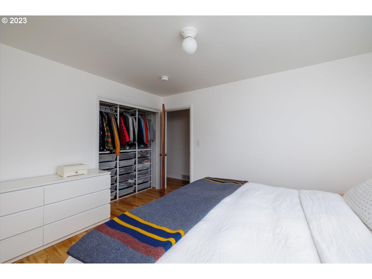 7519 Southwest 53rd Avenue Portland, OR 97219 - Photo 14 of 30 a bedroom with a bed and a book shelf