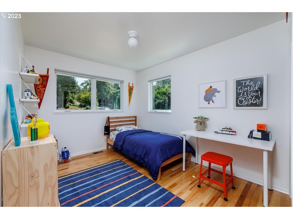 7519 Southwest 53rd Avenue Portland, OR 97219 - Photo 15 of 30 a bedroom with furniture and a window