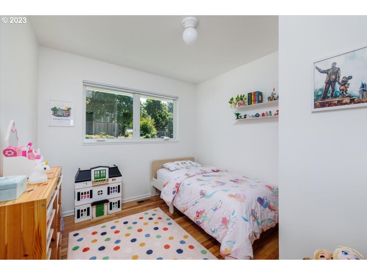 7519 Southwest 53rd Avenue Portland, OR 97219 - Photo 17 of 30 a bedroom with a bed and a dresser in it