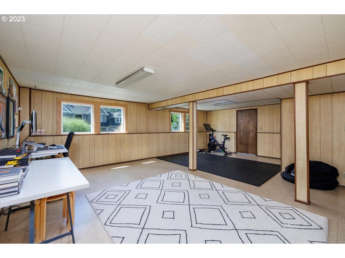 7519 Southwest 53rd Avenue Portland, OR 97219 - Photo 20 of 30 a living room with furniture mirror and a table