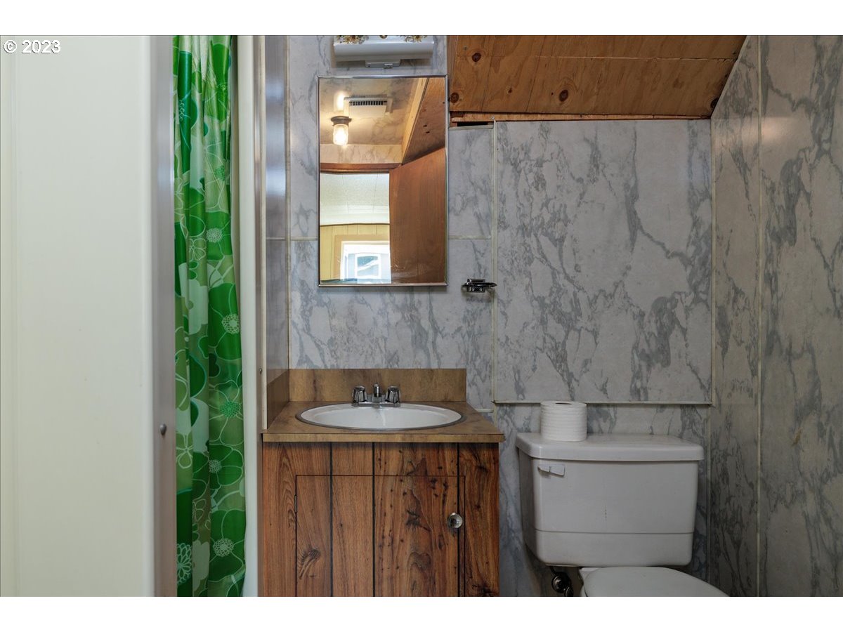 7519 Southwest 53rd Avenue Portland, OR 97219 - Photo 23 of 30 a bathroom with a sink and a mirror