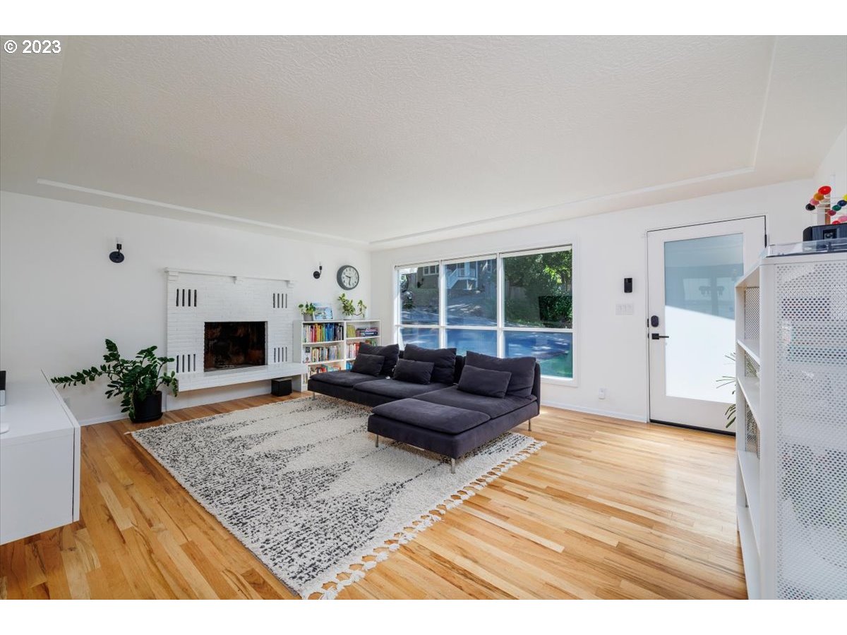 7519 Southwest 53rd Avenue Portland, OR 97219 - Photo 3 of 30 a living room with furniture and a fireplace