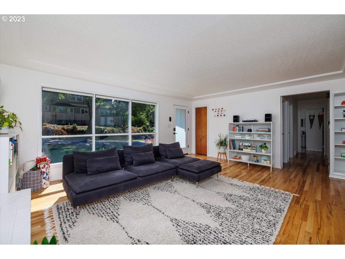 7519 Southwest 53rd Avenue Portland, OR 97219 - Photo 4 of 30 a living room with furniture and a large window