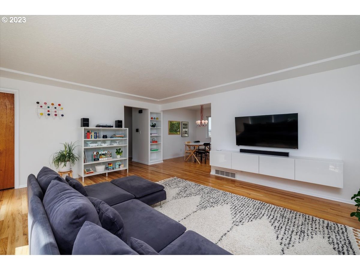 7519 Southwest 53rd Avenue Portland, OR 97219 - Photo 5 of 30 a living room with furniture and a flat screen tv