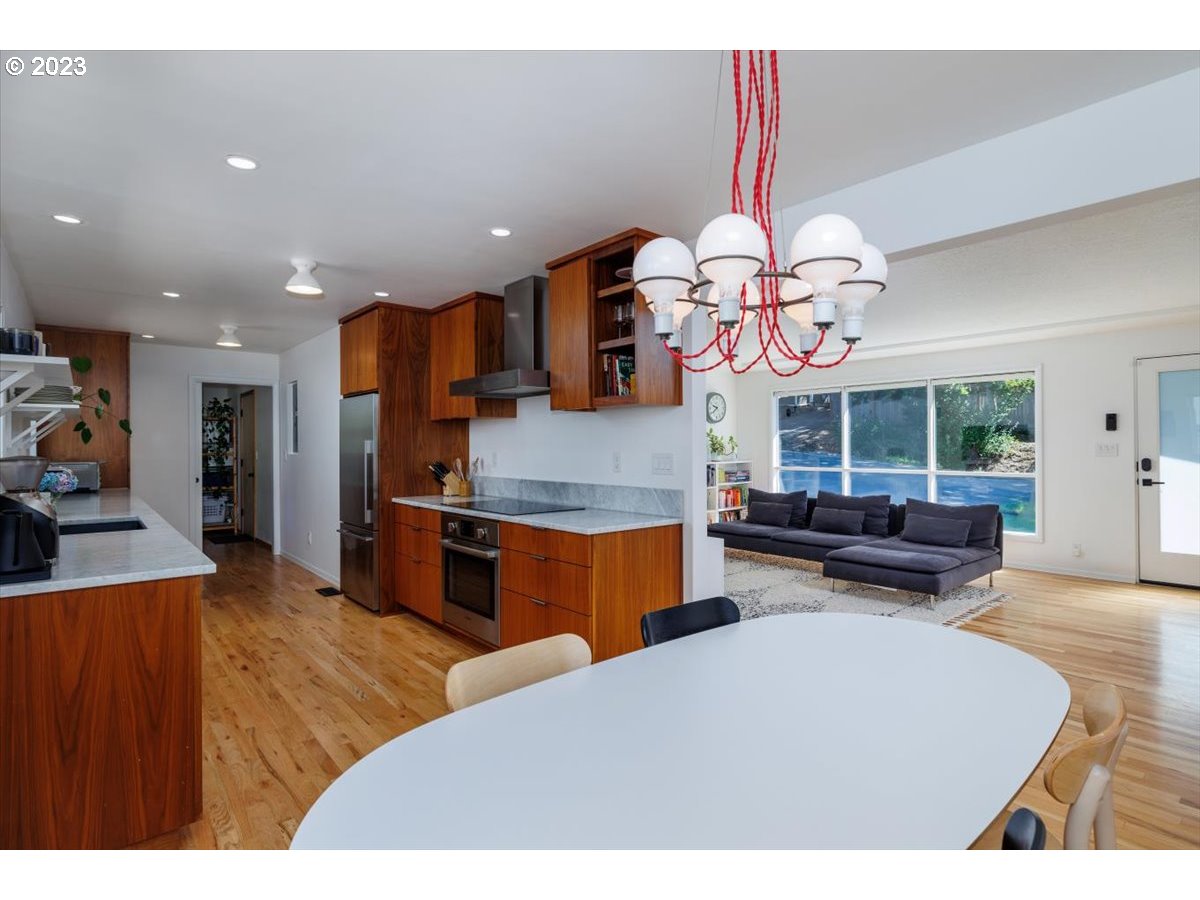 7519 Southwest 53rd Avenue Portland, OR 97219 - Photo 7 of 30 a living room with fireplace furniture and a chandelier