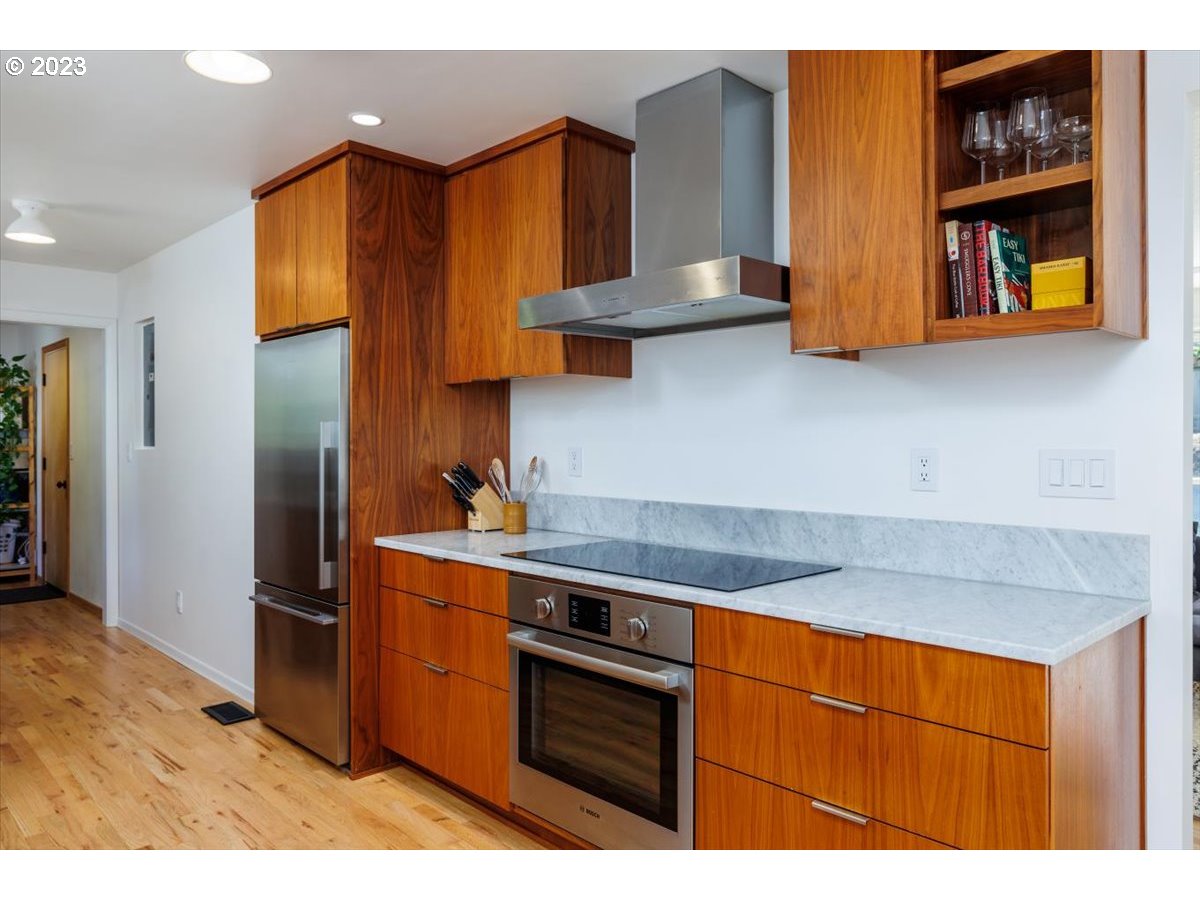 7519 Southwest 53rd Avenue Portland, OR 97219 - Photo 9 of 30 a kitchen with stainless steel appliances granite countertop a sink stove and refrigerator
