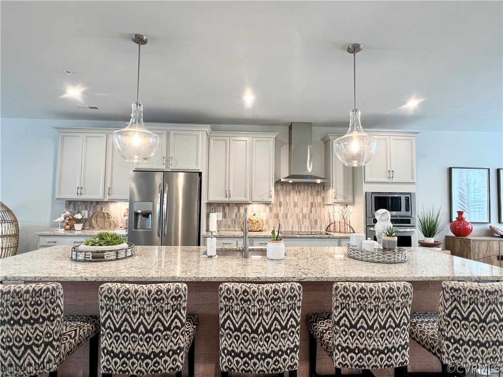a kitchen with granite countertop a sink cabinets and stainless steel appliances