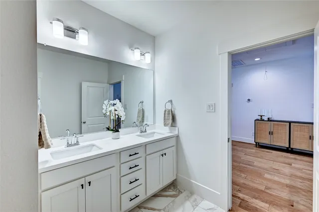 a view of a hallway with wooden floor and stairs
