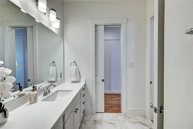 a bathroom with a double vanity sink mirror and
