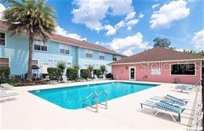 3930 Southwest 20th Avenue, Unit 1905 Gainesville, FL 32607 - Photo 1 of 1 a view of a house with a swimming pool and a chairs