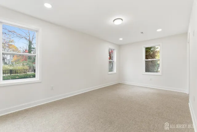 an empty room with a empty space and windows