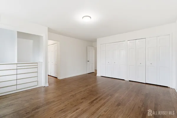 a view of a hallway with wooden floor and entryway