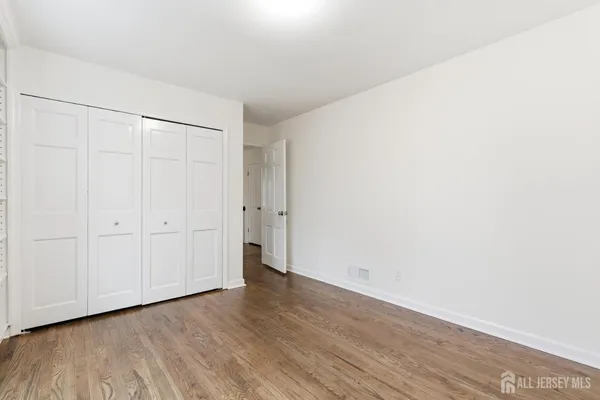 a bathroom with a granite countertop sink mirror and next to a window