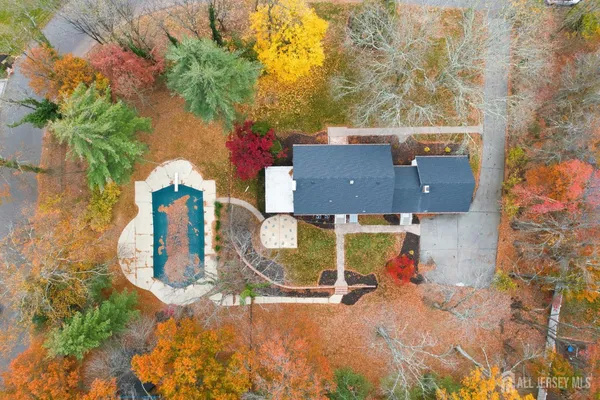 an aerial view of a house with a swimming pool