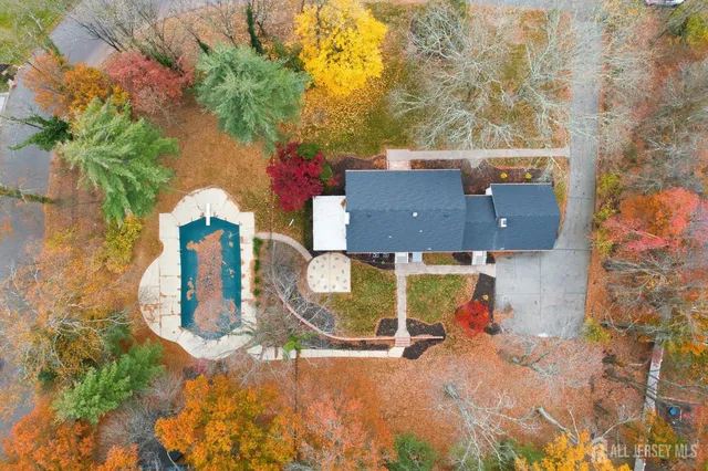 an aerial view of a house with a swimming pool