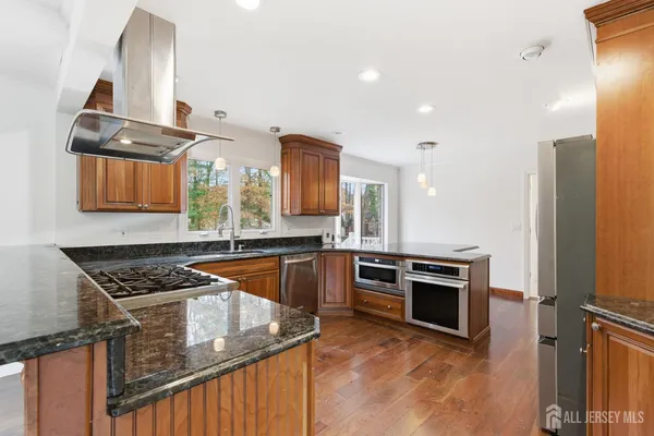 a kitchen with granite countertop a stove and a sink