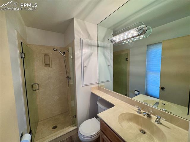 280 Raven Hills Road Colorado Springs, CO 80919 - Photo 29 of 48 Bathroom with vanity, a stall shower, and toilet