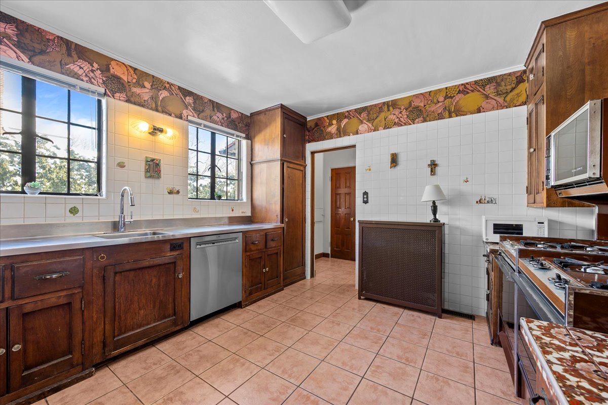 260 Oxford Road Kenilworth, IL 60043 - Photo 31 of 61 a kitchen with stainless steel appliances granite countertop a stove a sink and a microwave