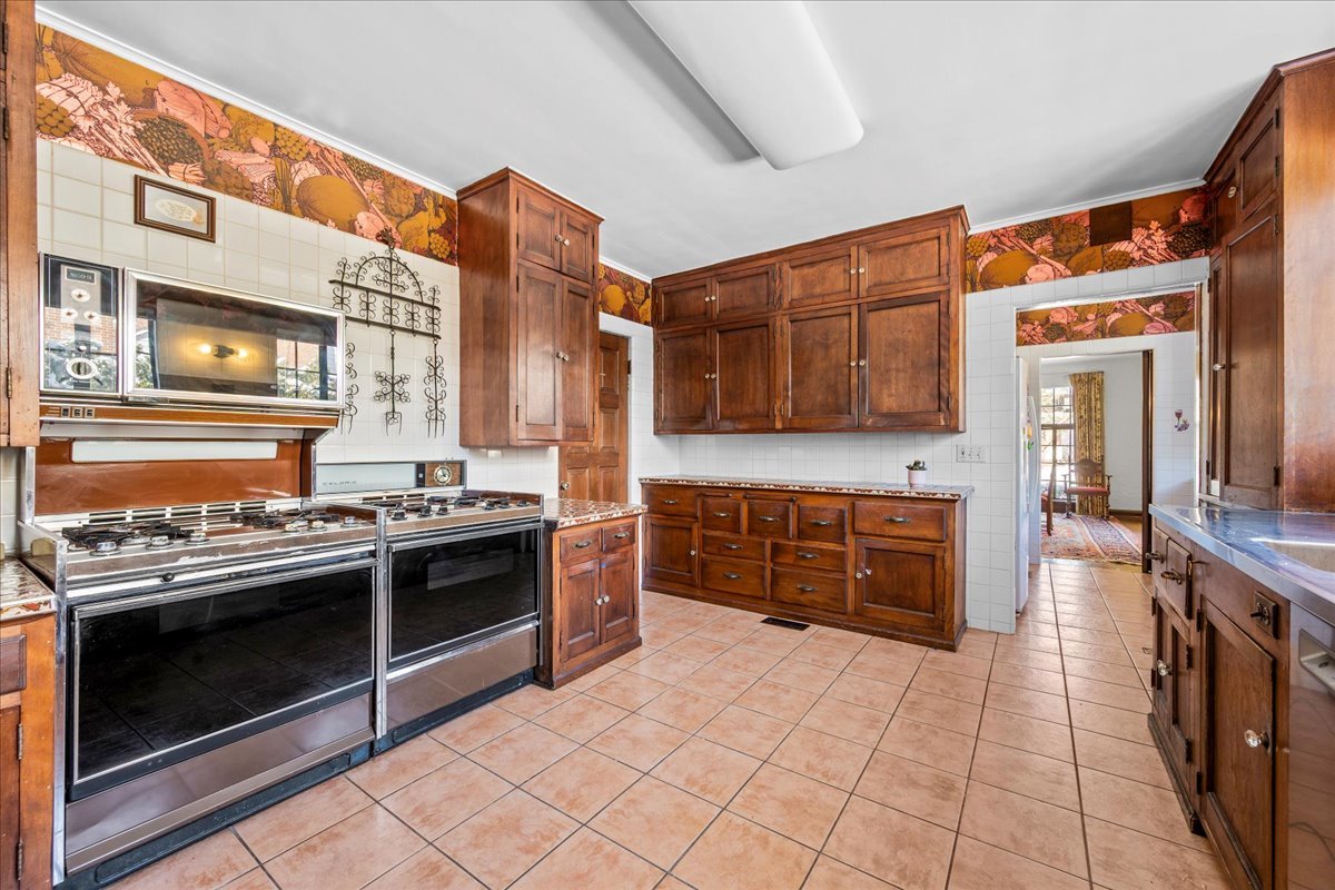 260 Oxford Road Kenilworth, IL 60043 - Photo 32 of 61 a kitchen with stainless steel appliances granite countertop a stove and a sink