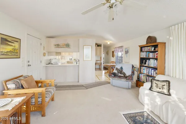 a living room with furniture and kitchen view
