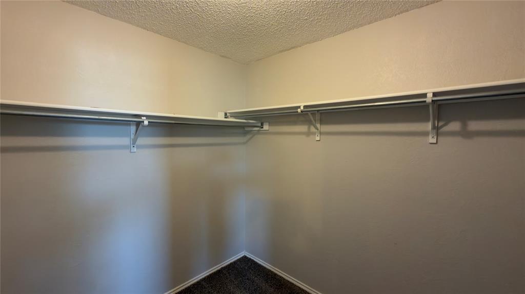3401 Cheyenne Ranch Road Fort Worth, TX 76262 - Photo 10 of 17 Wall-mounted shelving with integrated hanging rods