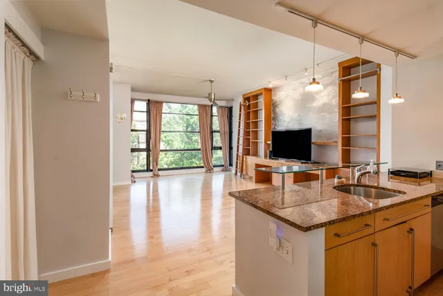 a kitchen with granite countertop a sink and a refrigerator