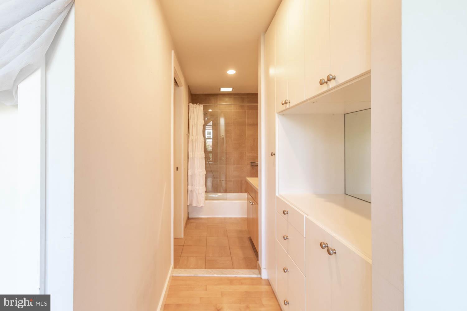 317-319 Vine Street, Unit 308 Philadelphia, PA 19106 - Photo 12 of 17 a bathroom with a glass shower door