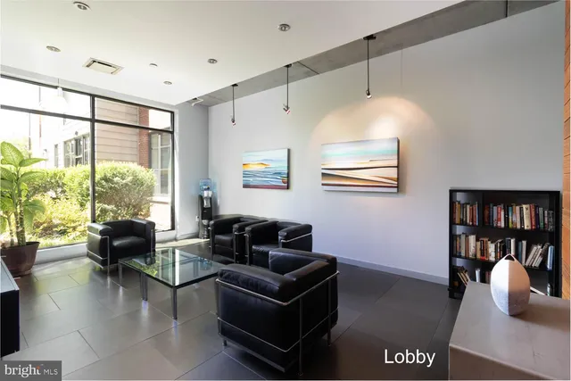 a living room with furniture and large window