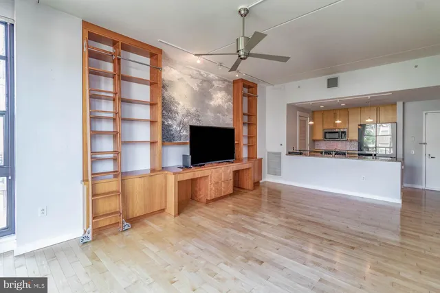 a view of a living room kitchen and a wooden floor