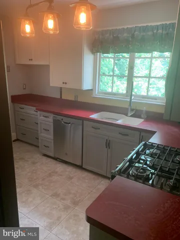 a kitchen with a stove and a sink