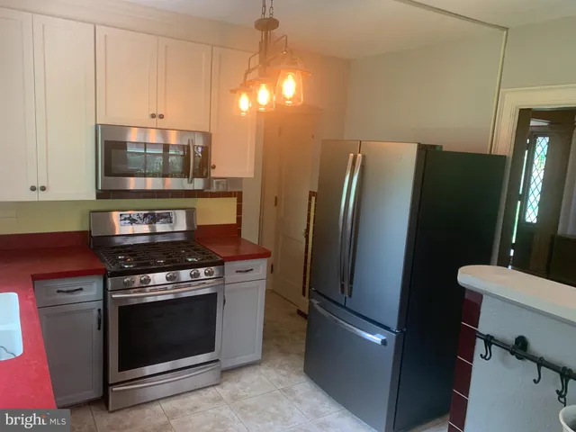 a kitchen with a stove and a refrigerator